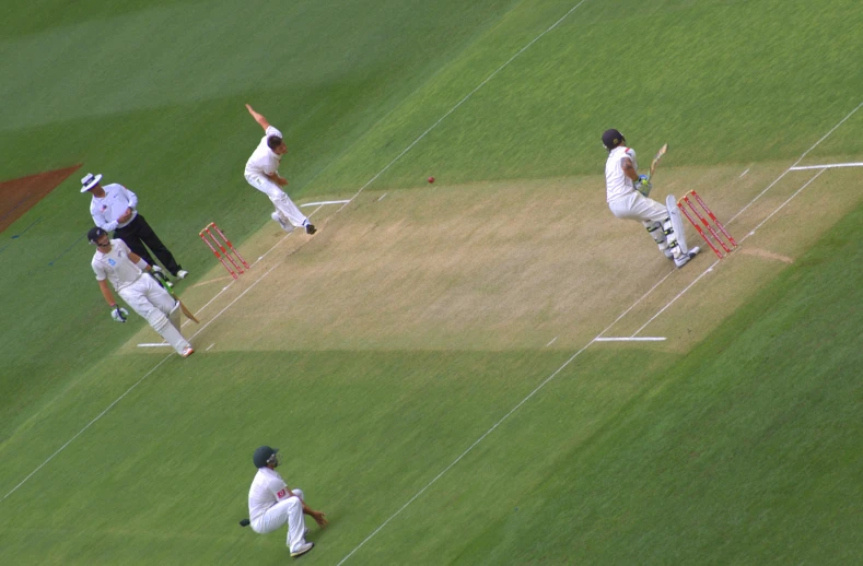 three professional players are playing a game of cricket on the field