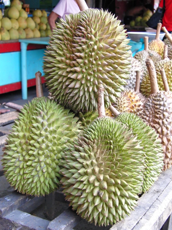 a bunch of fruit sit on display at a market