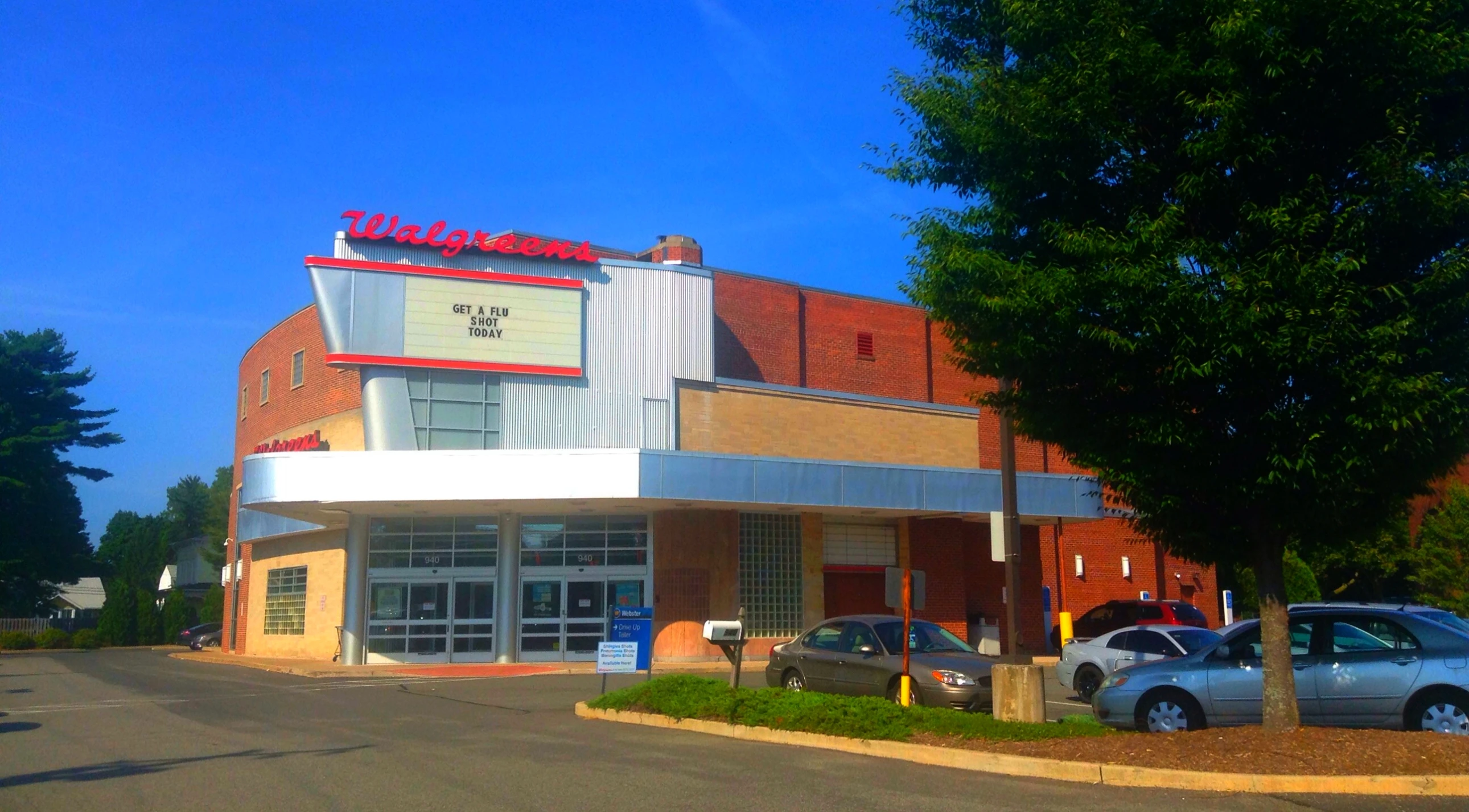 a commercial building with cars parked in front