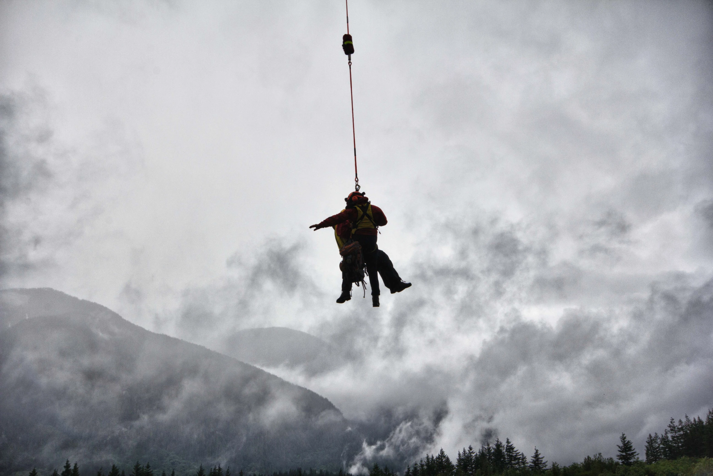 a person hanging upside down and wearing a harness