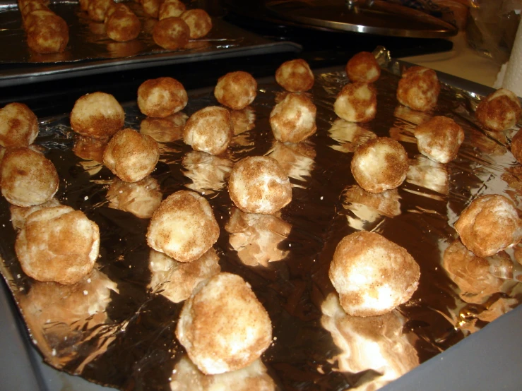 a tray of cooked pastries on a metal surface