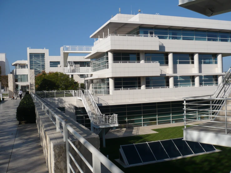 an exterior view of buildings and stairs, including the top half of a white building