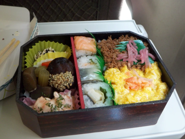 a wooden box filled with lots of sushi