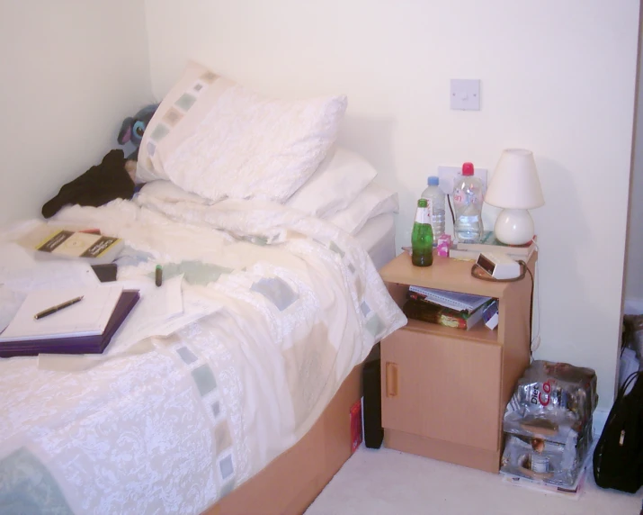 a small bedroom with some books on a desk