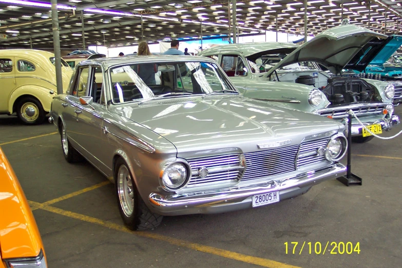 an older car parked in a garage with its hood up