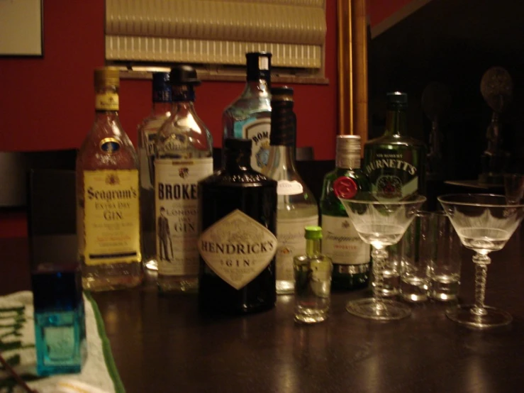 wine glasses and liquor bottles lined up on the counter