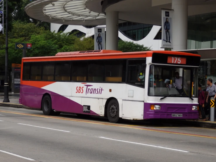 the bus is parked outside of the building