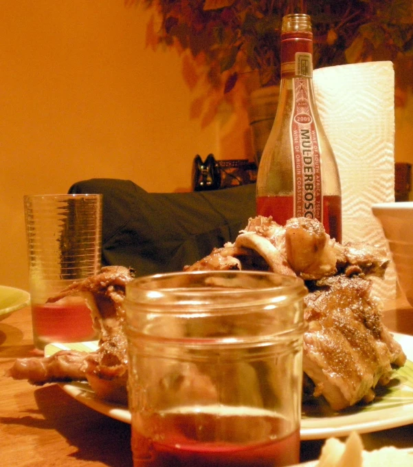 the meal is prepared on the table with the bottles of wine