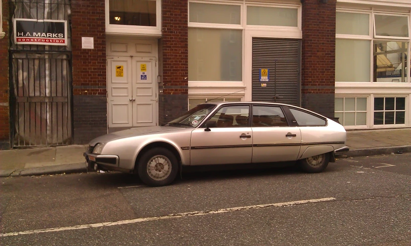 an old car parked on the side of the road