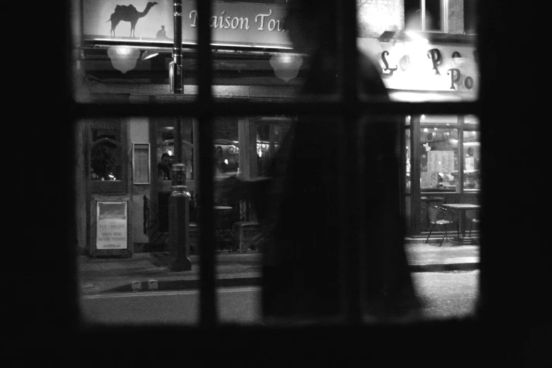 a window has reflection of the store at night