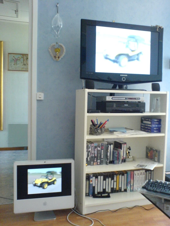 a television sitting next to an electronic device on a table