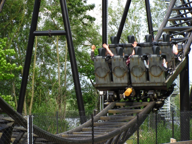 a roller coaster is shown with people on it