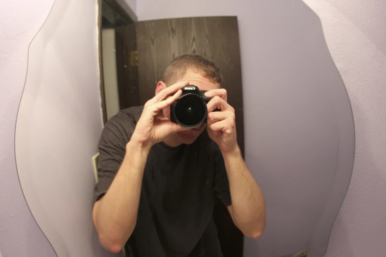 a man taking a picture in front of a mirror