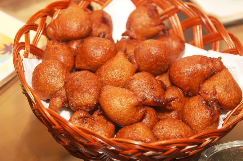 a wicker basket filled with sweet foods sitting on a table