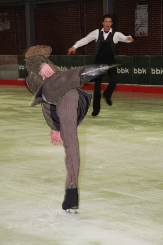 a person in a hat and a suit on a skateboard