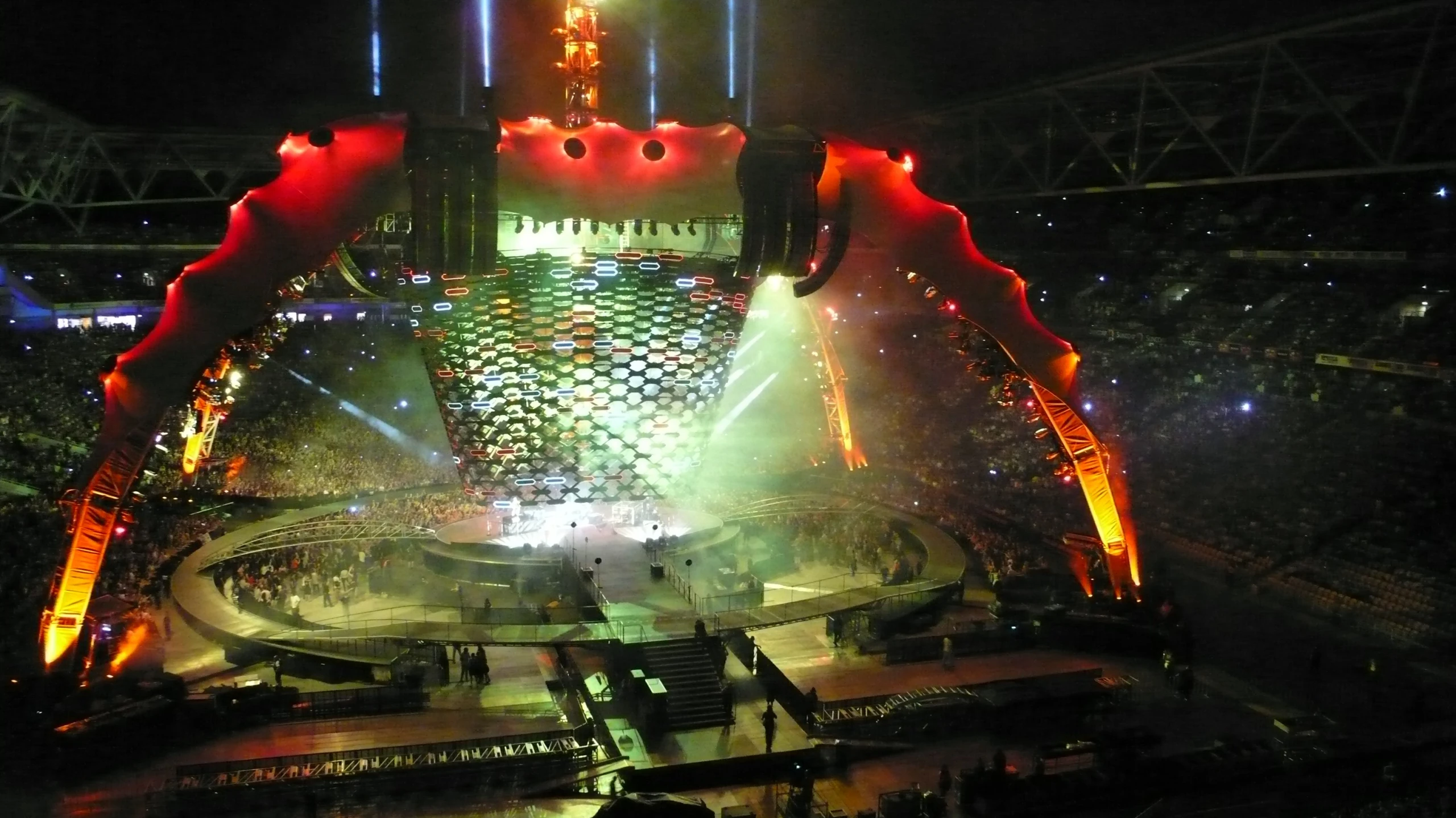 a huge stage has people sitting on chairs