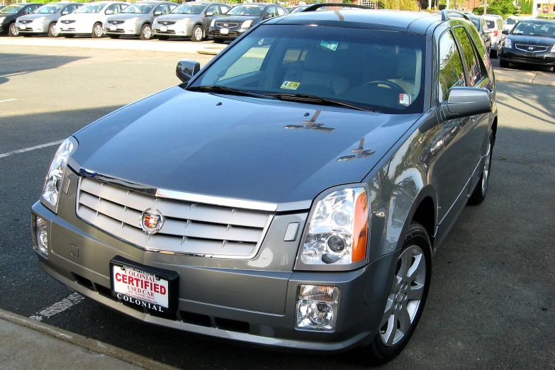 a cadillac parked on a parking lot in a car park