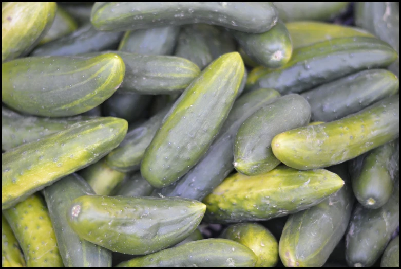 a pile of cucumbers that are sitting on a table