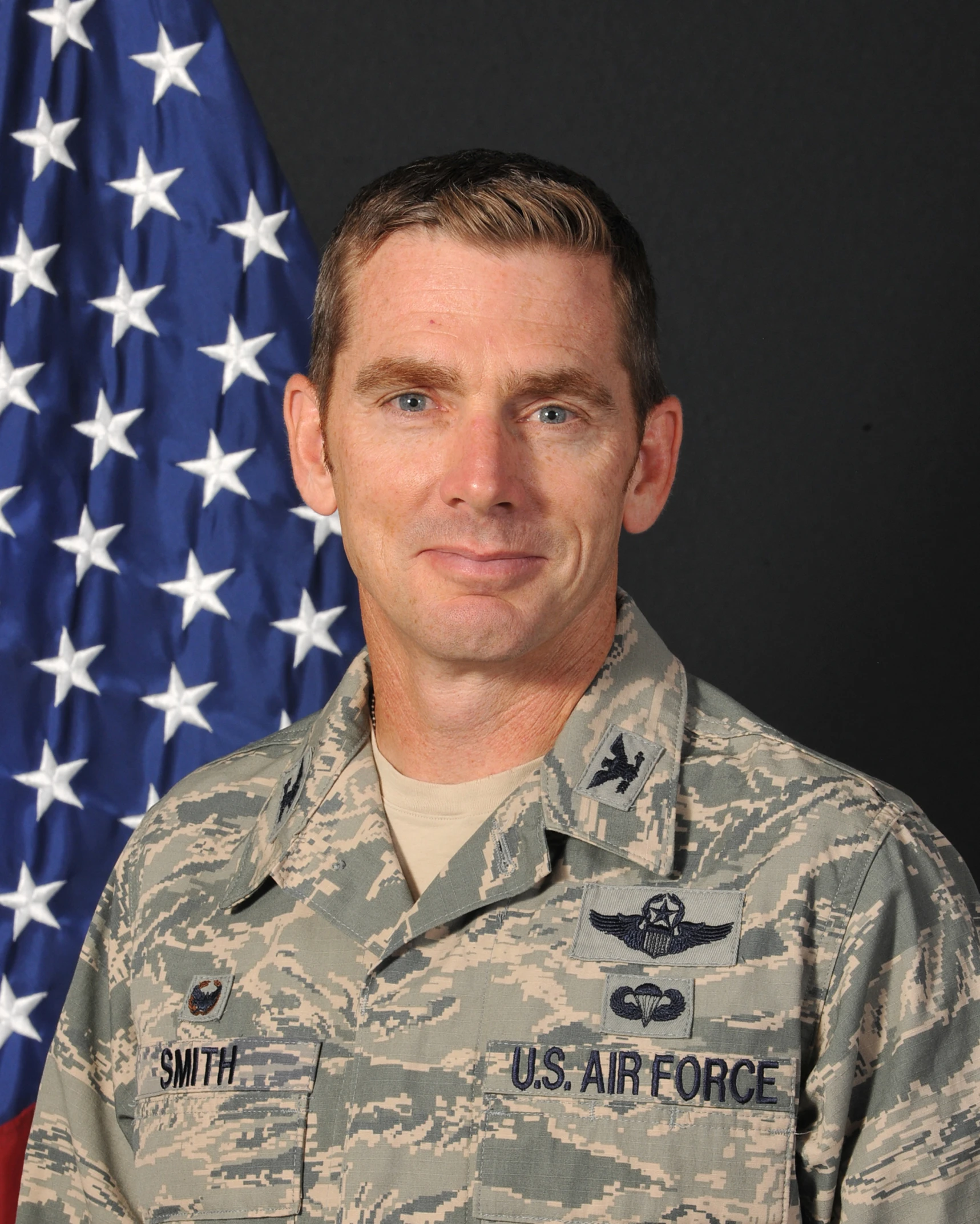 a man in uniform next to a flag