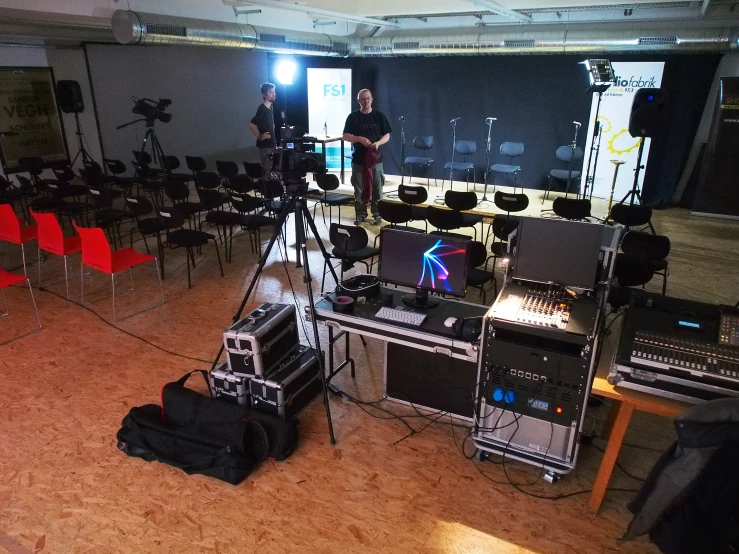 a recording studio with many chairs and audio equipment