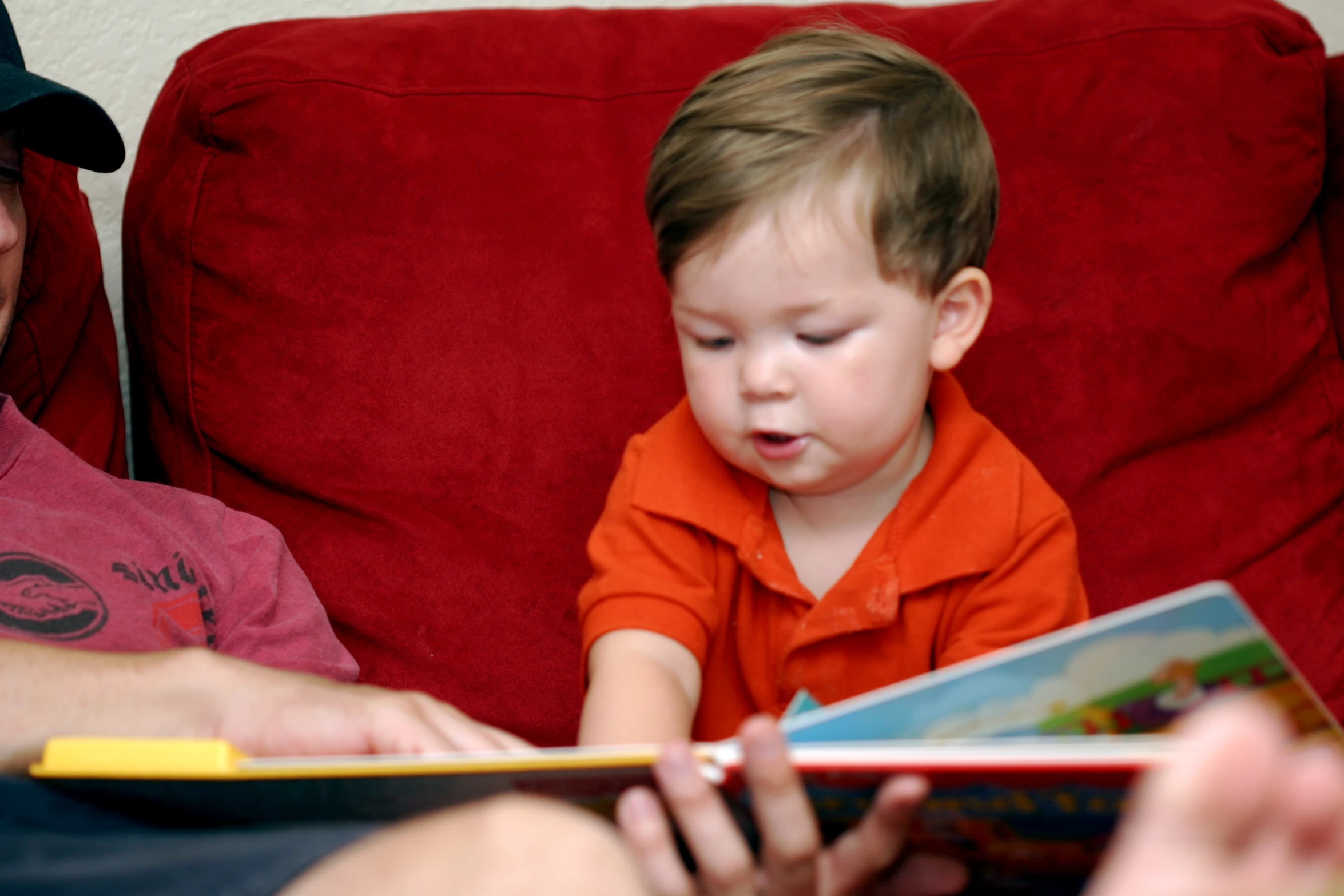 a man sitting next to a little boy