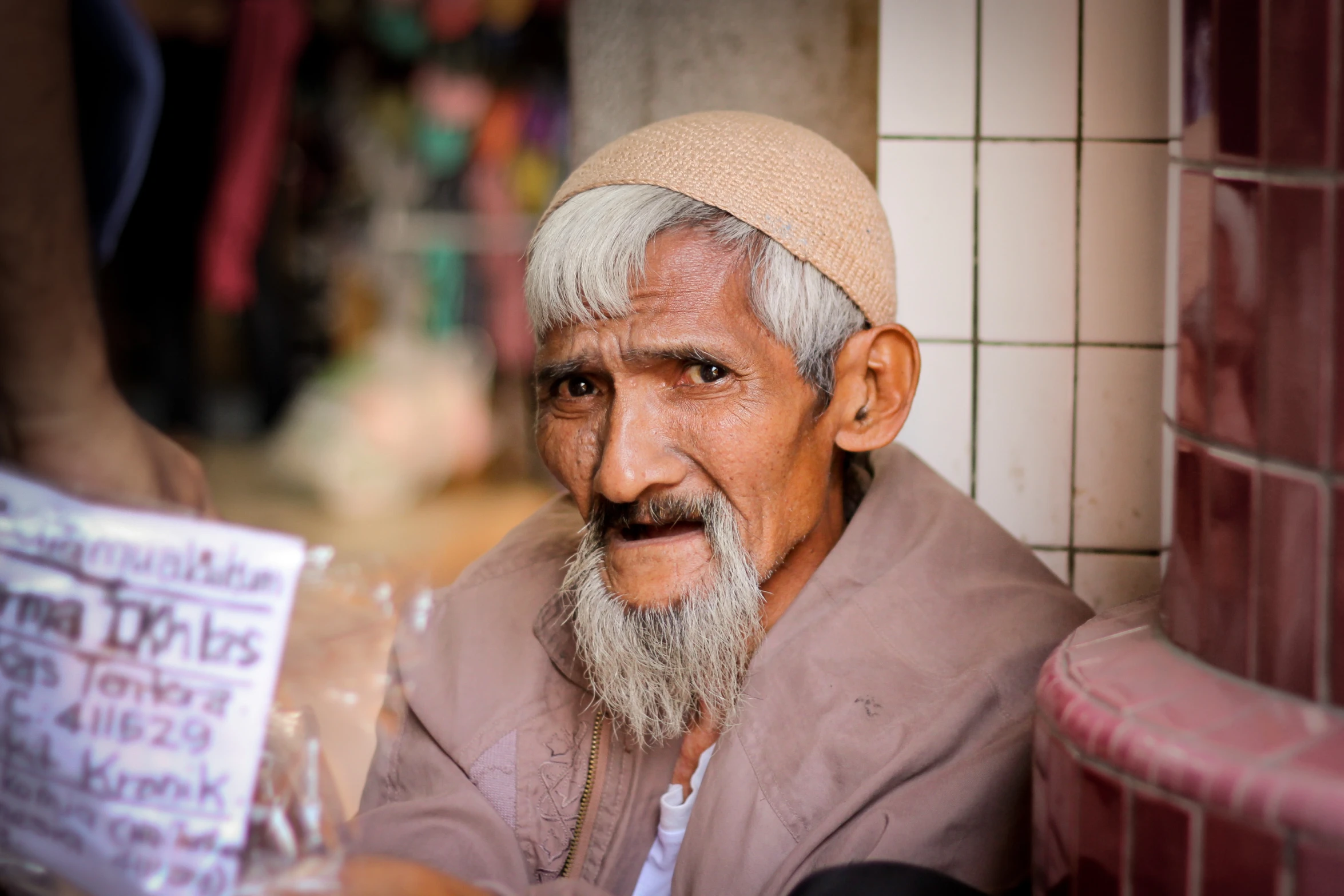 a man with long grey hair, wearing a straw hat