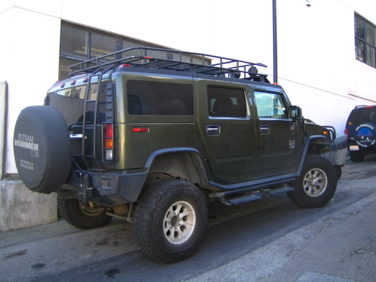 a large green truck with a rack on it's roof