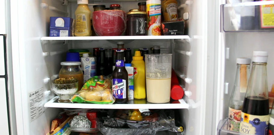 an open fridge has an assortment of condiments in it