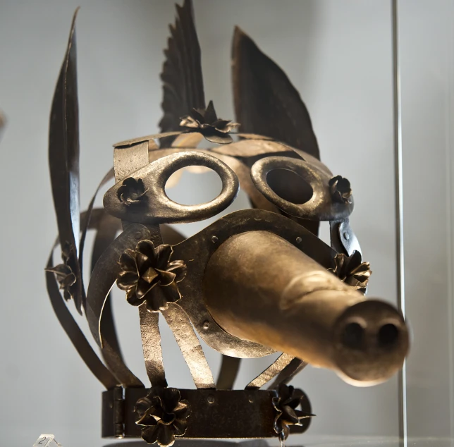 an artistic golden dog mask made of metal