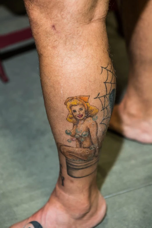 tattoo on the legs of a woman with a spider web net