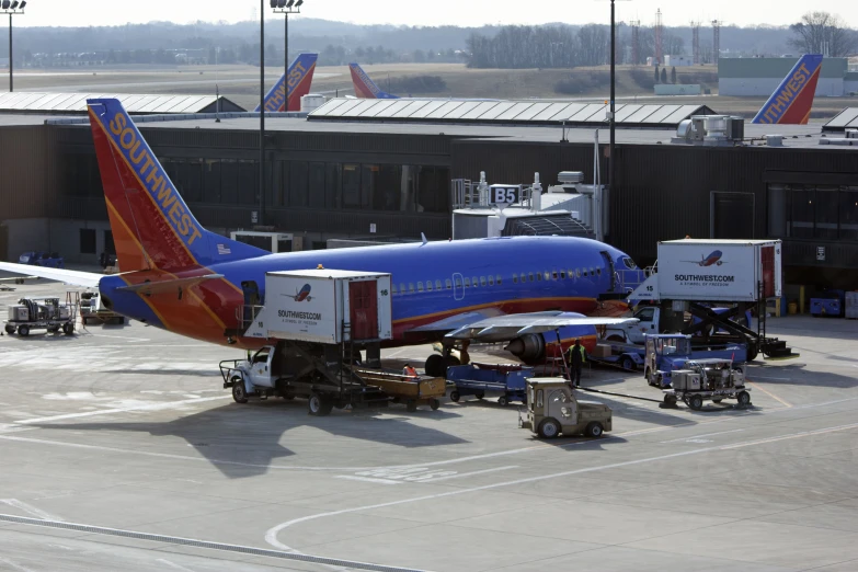 an orange and blue airplane and a couple of planes