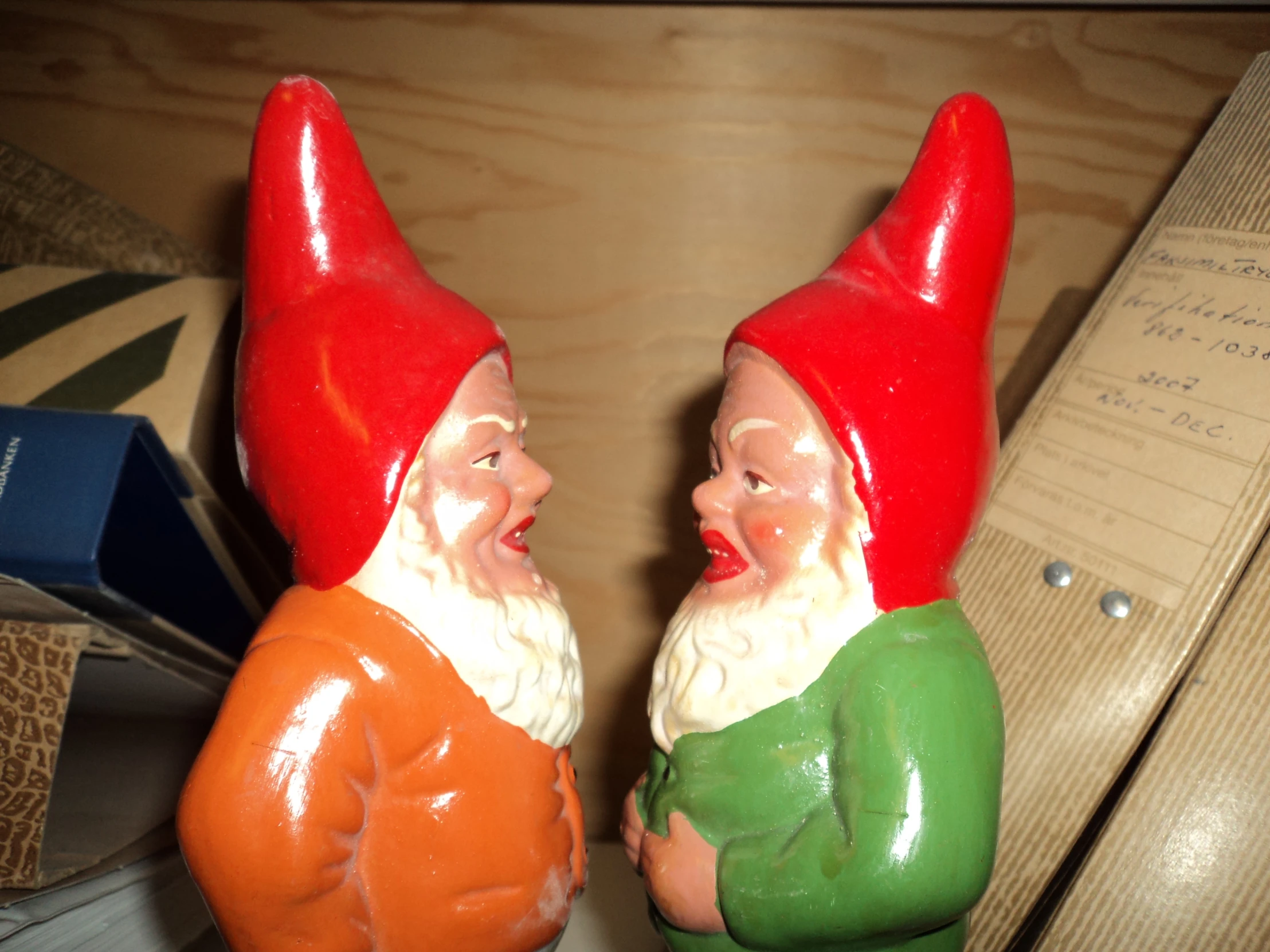 two ceramic gnome figurines on a desk