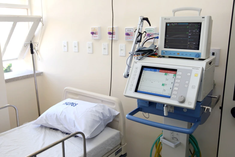 hospital room with monitor, patient bed and hospital equipment
