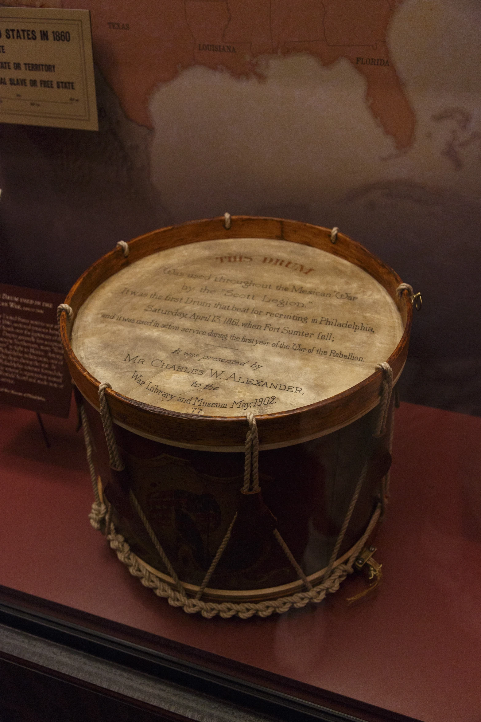 an unusual looking drum sits inside a museum exhibit