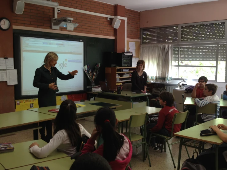 a teacher is teaching in a class room