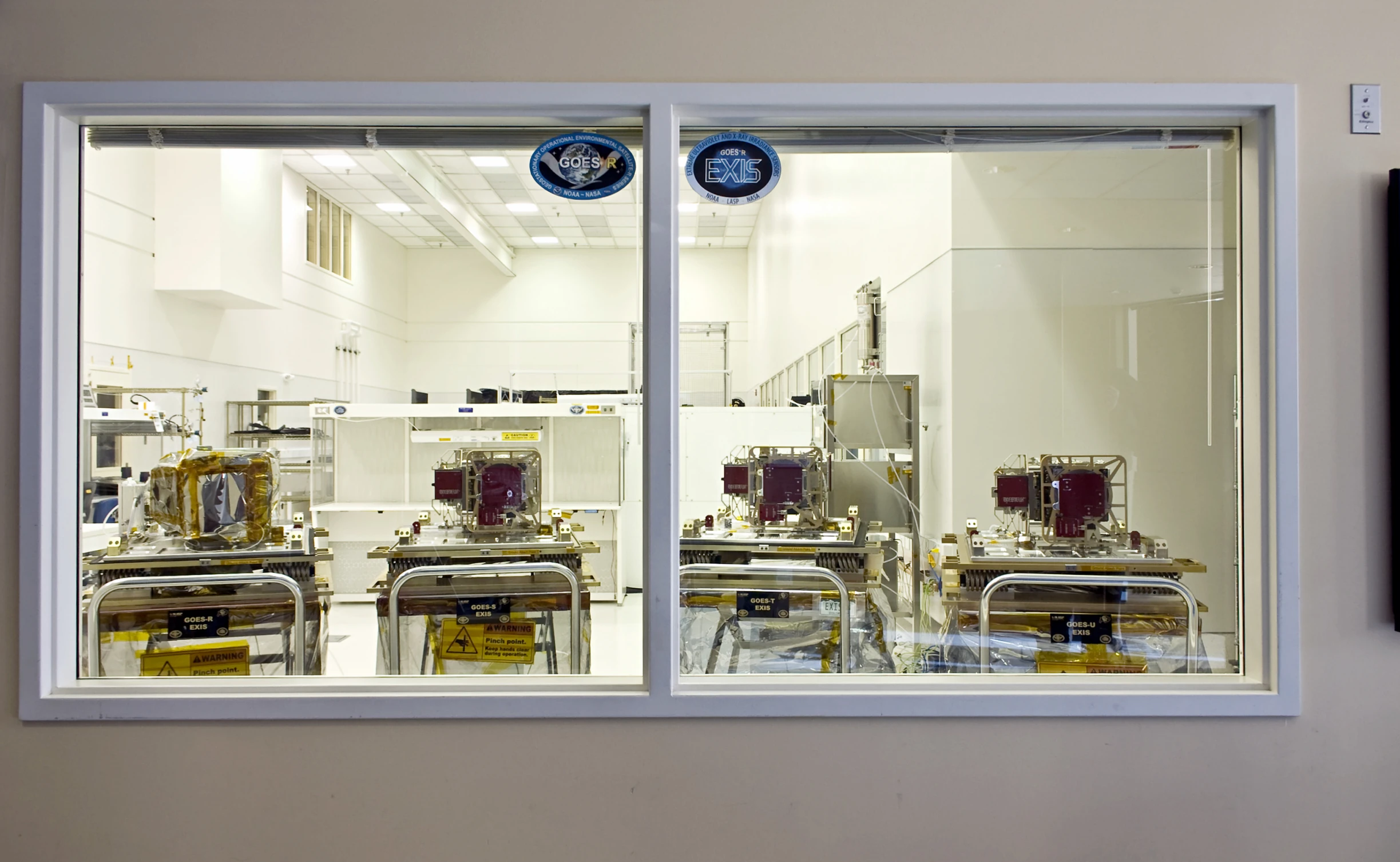 several machines in a factory on display in a window