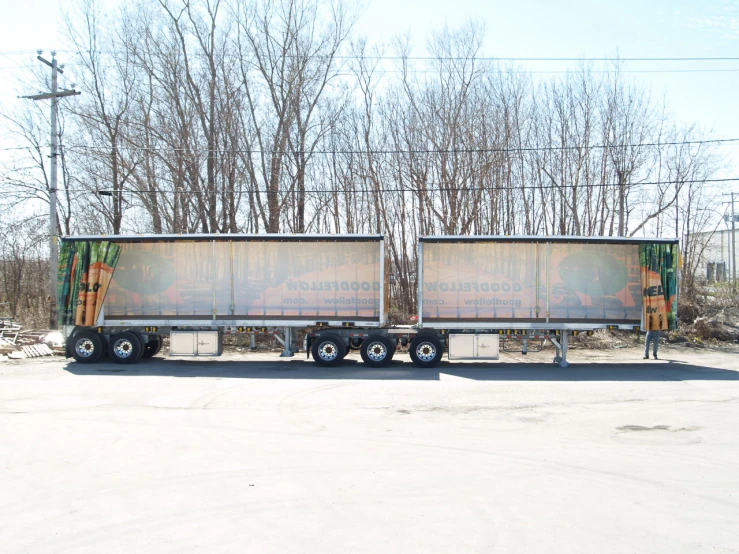 a truck is parked in a lot near trees