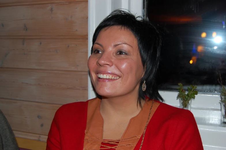 a women with a red shirt sitting in a chair