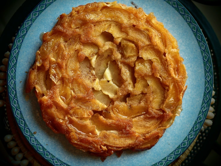 a piece of apple pie on a blue plate