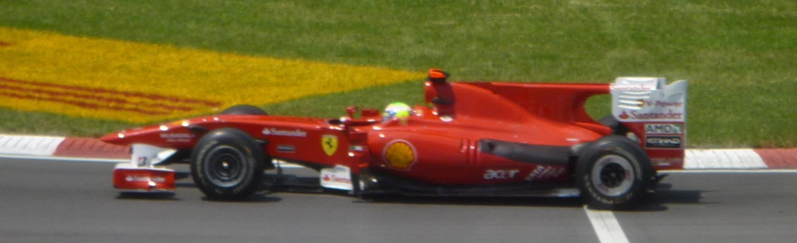 a red racing car turning on the track