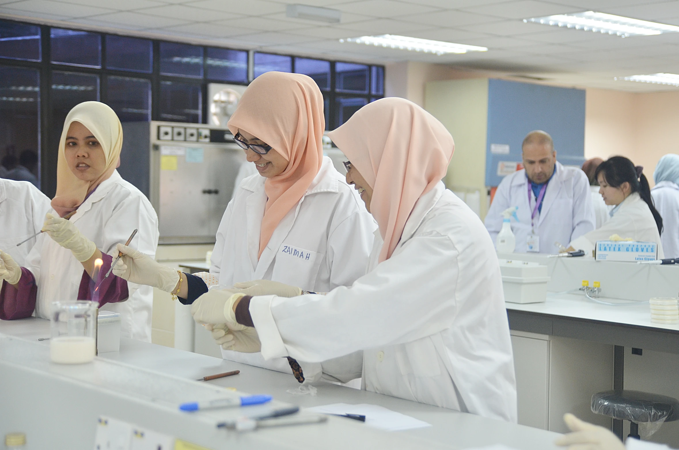 a group of people in a lab wearing gloves