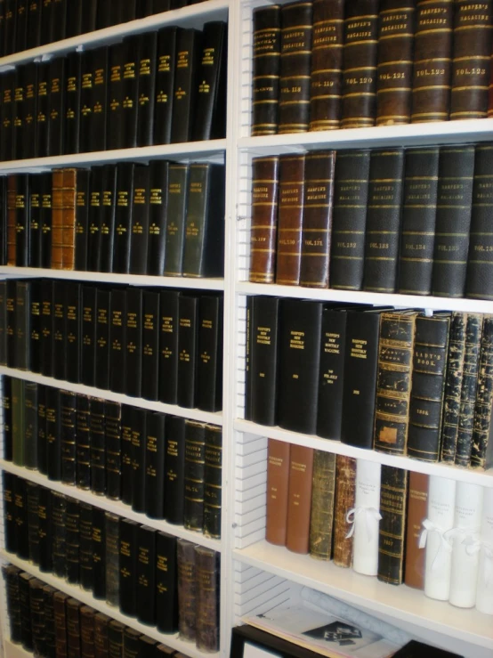 many large books on the shelf in the room