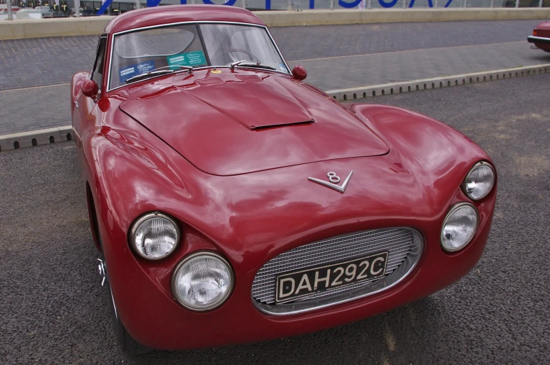 the old car is parked on the side of the road