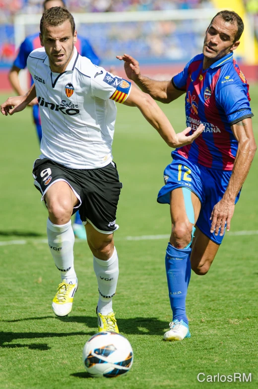 there are two men that are playing a soccer game