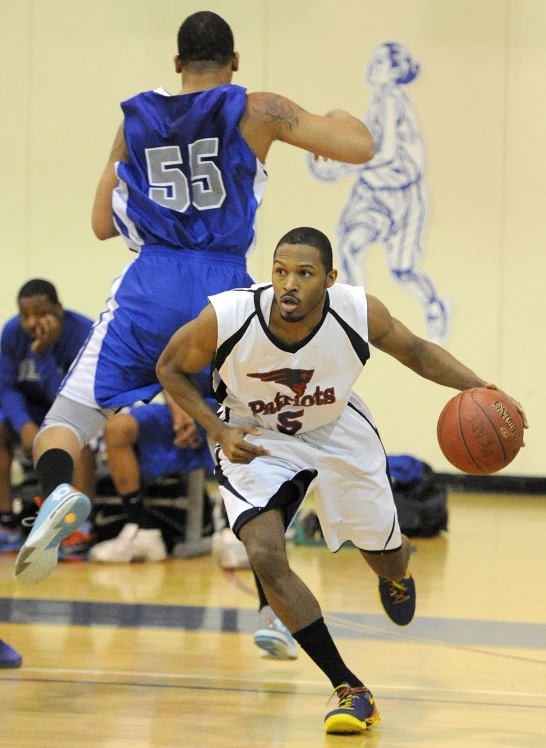 a basketball player is running towards another player