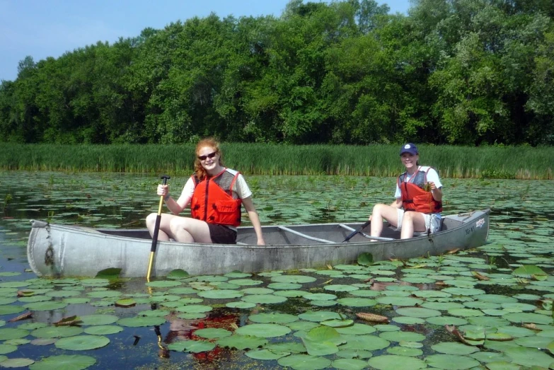 a couple of people on a canoe in a lake