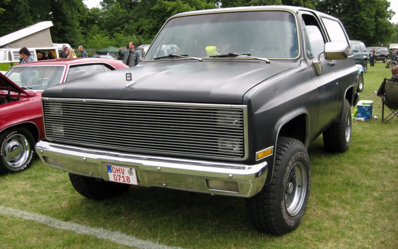 truck with large grilled front and small rear with chrome wheels
