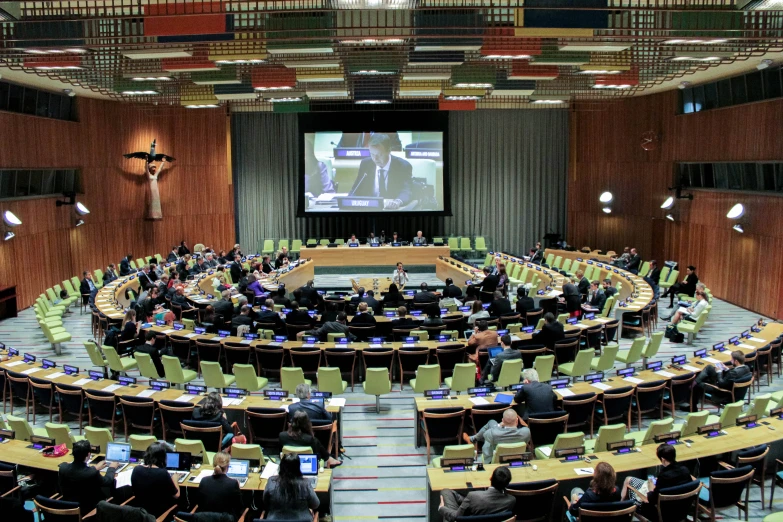 a group of people are in the middle of a conference hall