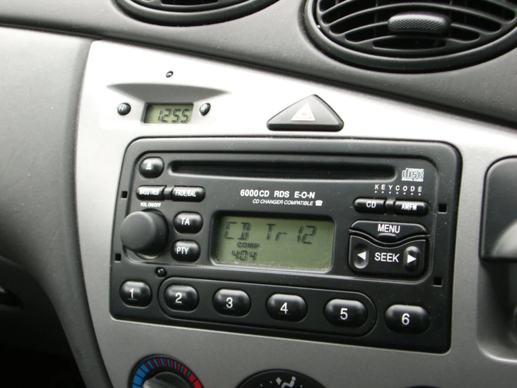 a digital clock sitting on top of an older car