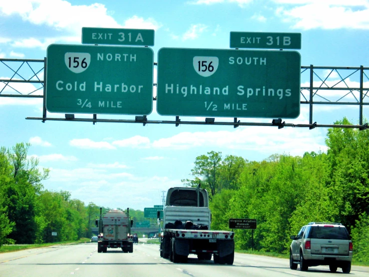 green highway signs with directions for highway and interstate exit sign